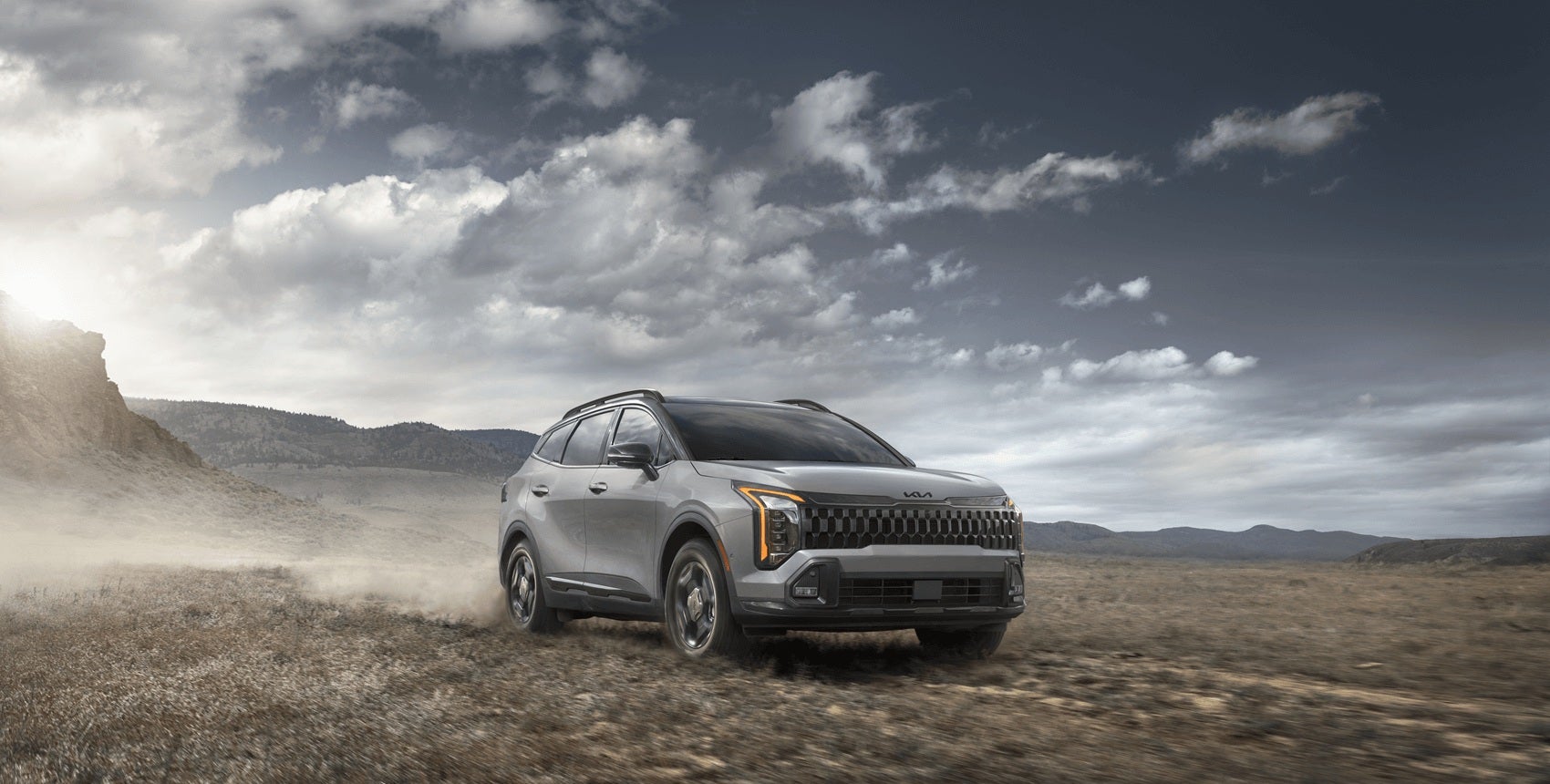 Kia Sportage driving through a dusty road
